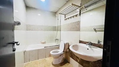 a bathroom with a toilet and a sink at The Flex Partition Room Near Mall of the Emirates in Dubai