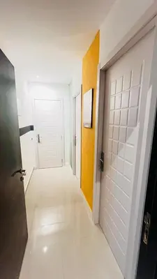 an empty hallway with a door and a hallwayngth at The Flex Partition Room Near Mall of the Emirates in Dubai
