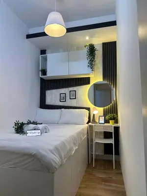 a bedroom with a large bed and a mirror at Executive Suite Room in Barsha 1 Near MOE Metro in Dubai