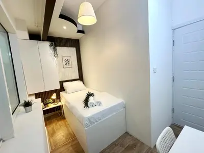 a small room with a bed in a room at Escape Partition Room in Barsha 1 Near MOE Metro in Dubai