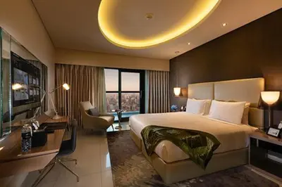 a hotel room with a large bed and a desk at DAMAC Towers by Paramount Hotels & Resorts Dubai in Dubai