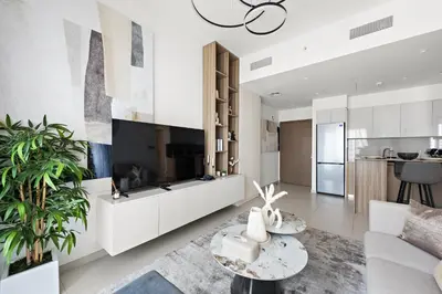 a living room with a couch and a table at Luxurious 1-Bedroom Apartment in Dubai