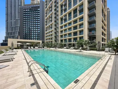 a large swimming pool in a city with tall buildings at Luxurious 1-Bedroom Apartment in Dubai