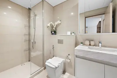 a bathroom with a shower and a toilet and a sink at Luxurious 1-Bedroom Apartment in Dubai