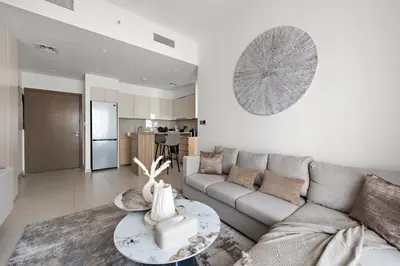 a living room with a couch and a table at Luxurious 1-Bedroom Apartment in Dubai