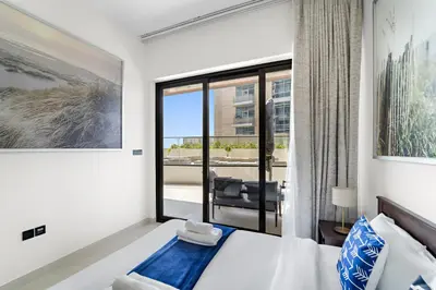 a bedroom with a bed and a large window at Elegant 1-Bedroom Apartment in Dubai