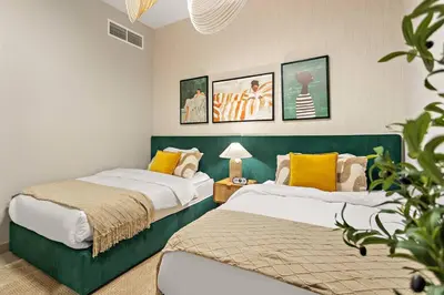 two beds in a room with yellow and white at Chic 2BR Stay at Creek Horizon with Pool, Gym and Prime Dubai Location in Dubai