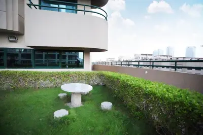 a white table in the grass in front of a building at The Hive Partition Room in Tecom Near Metro in Dubai