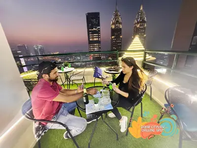 a man and woman sitting at a table on a rooftop at The Hive Partition Room in Tecom Near Metro in Dubai