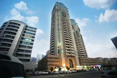 two tall buildings with cars parked in a city at Vista Partition Room in Tecom Near Internet City Metro in Dubai