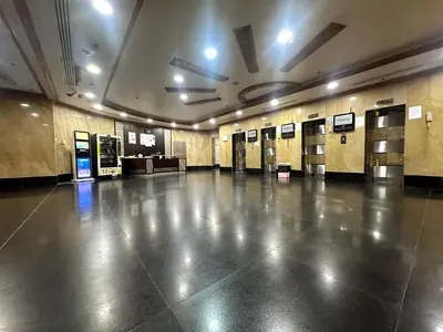 a large empty hall with doors and ailed floor at Cove Partition Room in Tecom Near Internet City Metro in Dubai