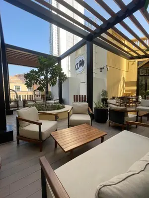 a patio with chairs and tables on a building at Luxury Studio in Murjan 2, JBR in Dubai