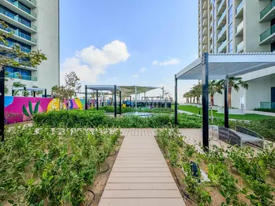 a walkway in a park next to a building at Stylish 1-Bedroom in Prime Business Bay Aykon C in Dubai