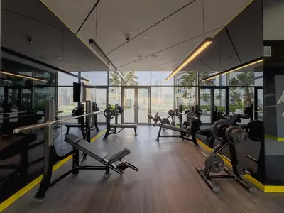 a gym with lots of treadmills and machines at Stylish 1-Bedroom in Prime Business Bay Aykon C in Dubai