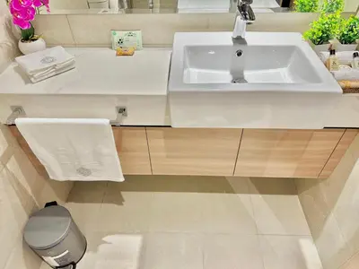 a bathroom with a white sink and a toilet at Cozy Retreat, Relax and Explore in Dubai