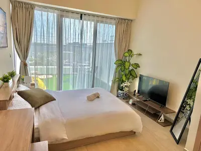 a bedroom with a large bed and a large window at Cozy Retreat, Relax and Explore in Dubai