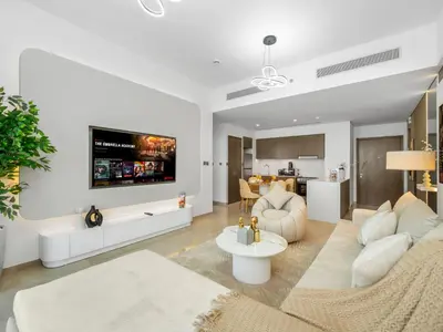 a living room with white furniture and a tv on the wall at SmartStay at Grande Signature - Downtown Dubai City Views - Brand New Luxury Apartments in Dubai