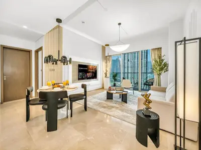 a living room with a dining room table and a couch at SmartStay at Grande Signature - Downtown Dubai City Views - Brand New Luxury Apartments in Dubai