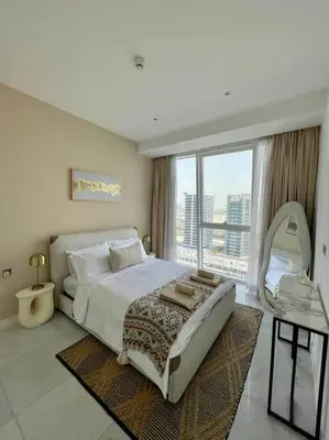 a bedroom with a large bed and a large window at 1BDR-furnished apartment, Business Bay, CANAL VIEW in Dubai