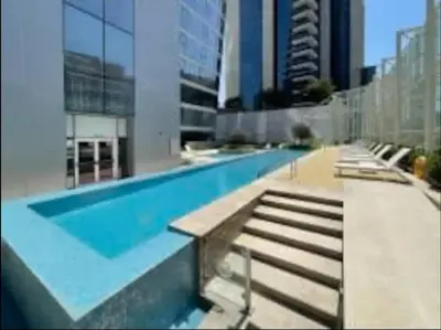 a swimming pool in a building with stairs and buildings at 1BDR-furnished apartment, Business Bay, CANAL VIEW in Dubai
