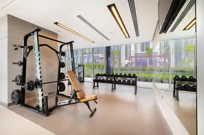 a fitness room with a gym with tread machines at Modern Home on 33rd Floor in Dubai Creek in Dubai
