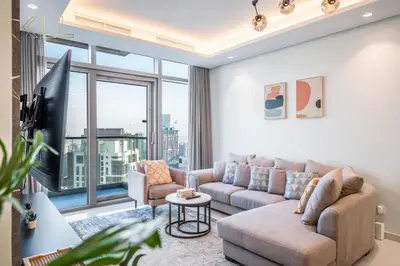 a living room with a couch and a large window at Luxury 2-Bed in Paramount Midtown Hotel Full Burj Khalifa Views 64th Floor Pool & Burj Views in Dubai