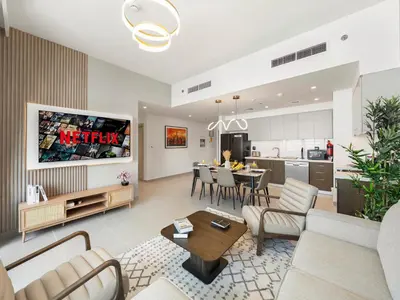 a living room with a couch and a dining room at Brand New Downtown unit! Bvlgari World Island View in Dubai