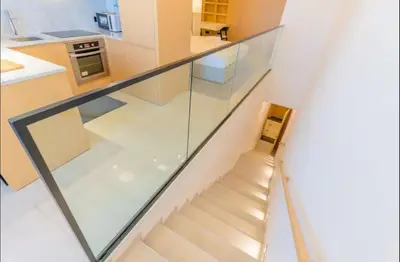 a staircase in a house with a glass wall at AWS Holiday Homes - Tranquil Stay at the Palm in Dubai