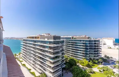 an aerial view of a large apartment building next to the beach at AWS Holiday Homes - Tranquil Stay at the Palm in Dubai