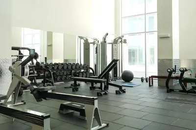 a gym with a lot of treadmills and machines at Premium Home with Panoramic Burj Khalifa Views in Dubai