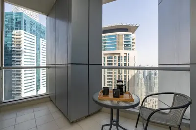a table and chair in a room with a window at Stunning Interior in an deal Location in Dubai