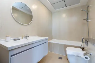 a bathroom with a sink and a toilet and a mirror at Stunning Interior in an deal Location in Dubai