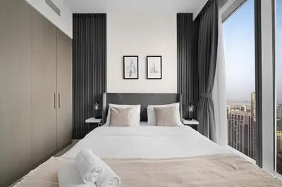 a bedroom with a large bed and a large window at Casa Nomad - Full Burj Khalifa & Fountain View at Luxury 4 Bed in Dubai