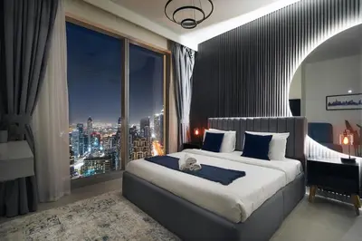 a bedroom with a large bed and a large window at Casa Nomad - Full Burj Khalifa & Fountain View at Luxury 4 Bed in Dubai