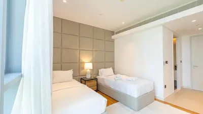 a bedroom with two beds and a window at Bluewaters Island - Luxury 2BR with Ain View by TLRE Holiday Homes in Dubai