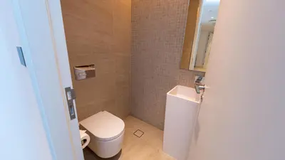 a small bathroom with a toilet and a sink at Bluewaters Island - Luxury 2BR with Ain View by TLRE Holiday Homes in Dubai