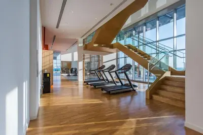 a lobby with a staircase and a row of chairs at Bluewaters Island - Luxury 2BR with Ain View by TLRE Holiday Homes in Dubai