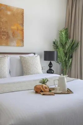 a tray of food sitting on top of a bed at Frank Porter - Damac Ghalia in Dubai
