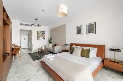 a bedroom with a large bed and a living room at Silkhaus Ocean View in Palm Views Holiday Vibes in Dubai