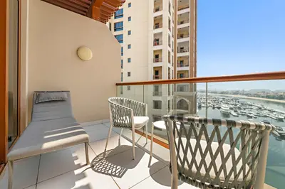 a balcony with a bench and a view of a harbor at Silkhaus Ocean View in Palm Views Holiday Vibes in Dubai