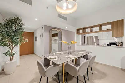 a dining room with a table and chairs at 4BR with Spacious Balcony & Stunning Burj Khalifa Views in Dubai