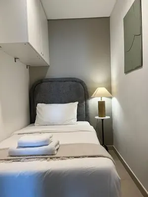 a bedroom with a bed with two towels on it at 4BR with Spacious Balcony & Stunning Burj Khalifa Views in Dubai