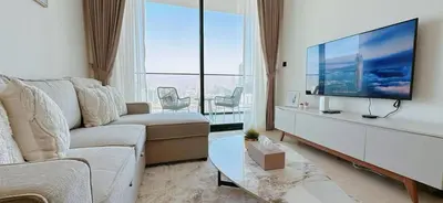 a living room with a large flat screen tv at Modern 1br In Jvc Balcony, Pool & Free Parking in Dubai