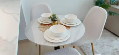 a white table with white cups and saucers on it at Modern 1br In Jvc Balcony, Pool & Free Parking in Dubai