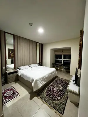 a bedroom with a large bed and a living room at Elite Residence Appartment 4007 in Dubai