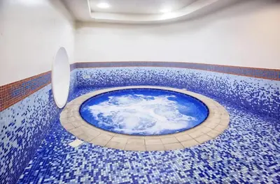 a room with a blue tile floor with a blue tub at Elite Residence Appartment 4007 in Dubai