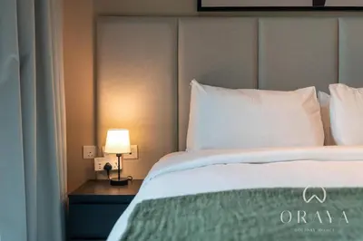 a bedroom with a bed and a lamp on a table at Luxurious Studio In Seven Palm Hotel & Apartments in Dubai