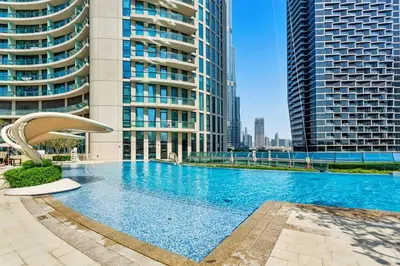 a large swimming pool in front of tall buildings at Bright One BDR close to Burj Khalifa & Dubai Mall in Dubai