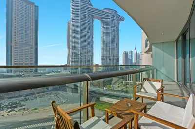 a balcony with chairs and a view of the city at Bright One BDR close to Burj Khalifa & Dubai Mall in Dubai