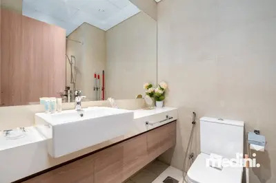 a bathroom with a sink and a toilet at Studio - Azizi Riviera 37 in Dubai